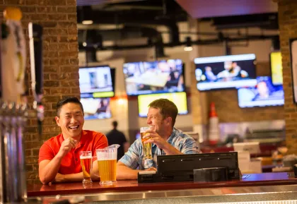 Friends hanging out at River Rock Sportsbook & Grill in Little River Casino Resort